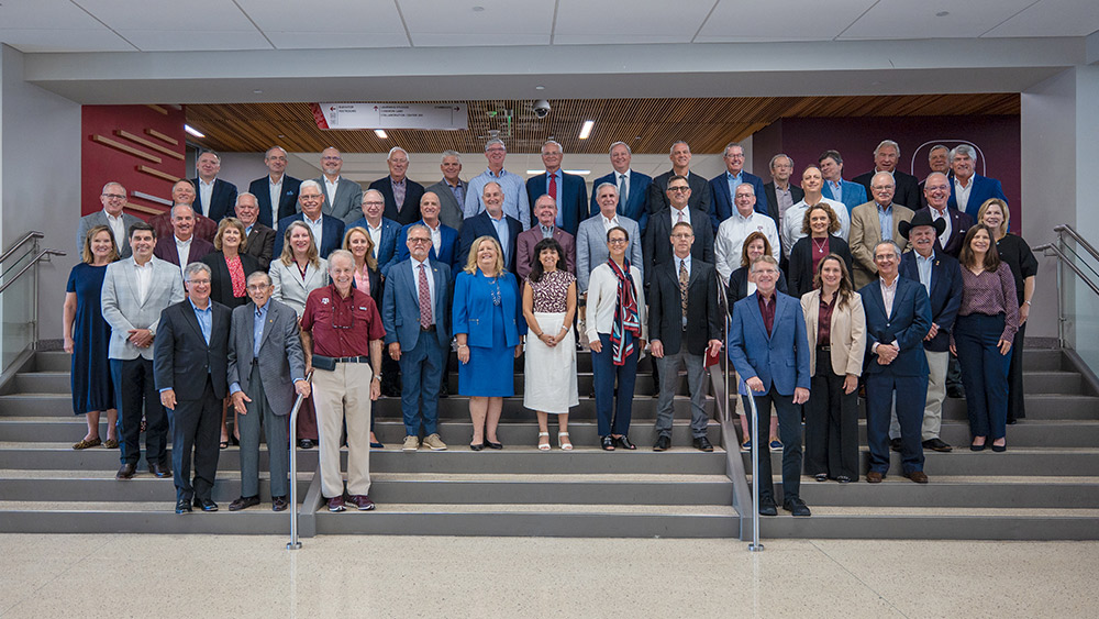 Group of Engineering Advisory Council Members standing on stairs in the Zachry building