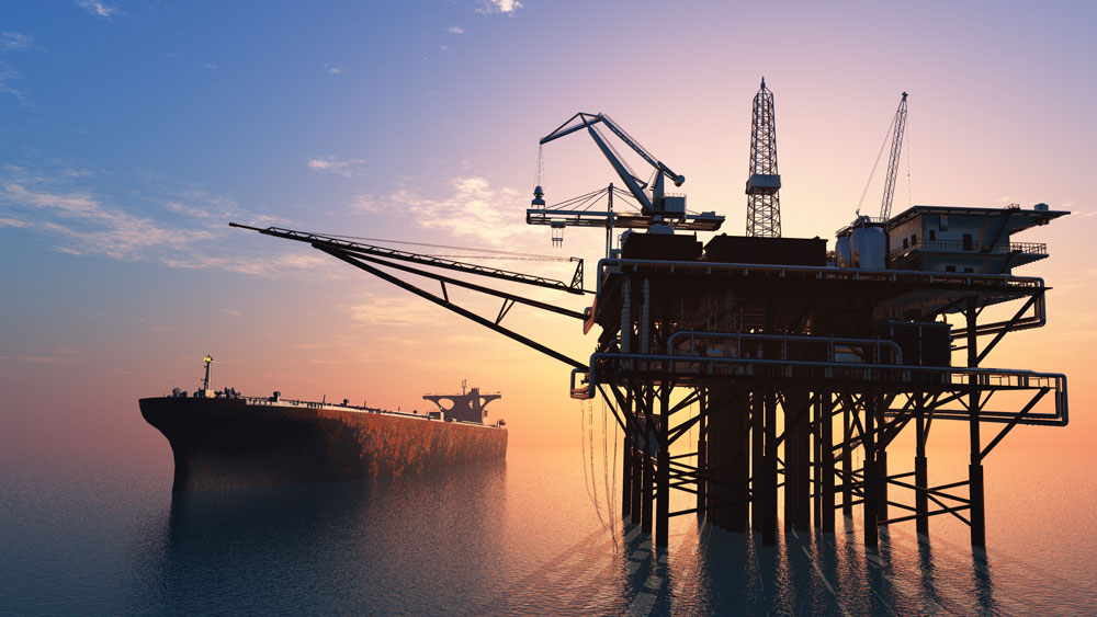 oil tanker close to an offshore oil rig in the ocean