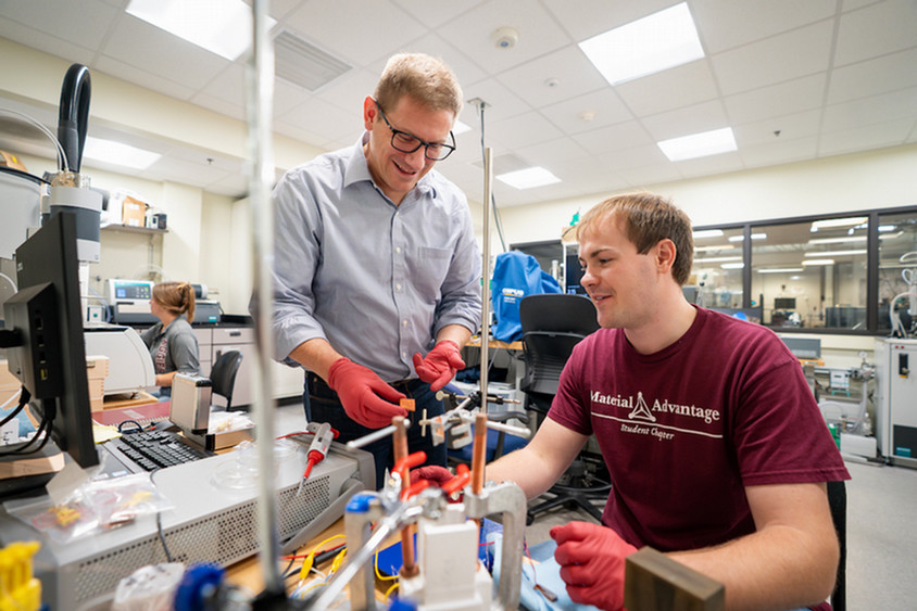 Two men working in a lab together.