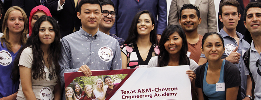 Students standing behind academy banner