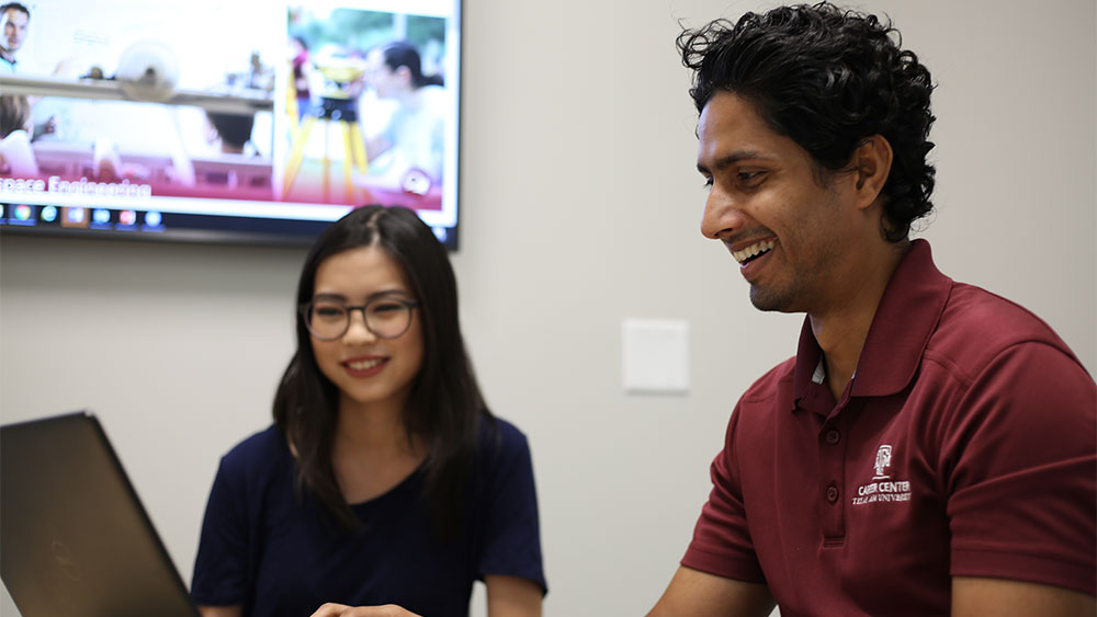 Student and career advisor work together in a huddle room.