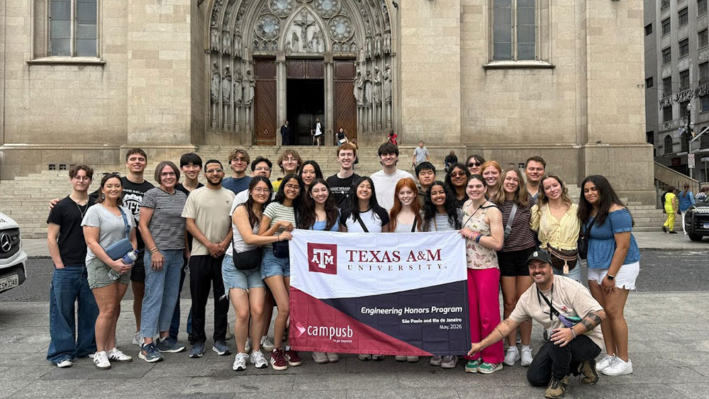 several students stand before an old church holding a banner: Texas A&amp;M University, Engineering Honors Program, Sáo Paulo and Rio de Janiero, May 2026, campusb.