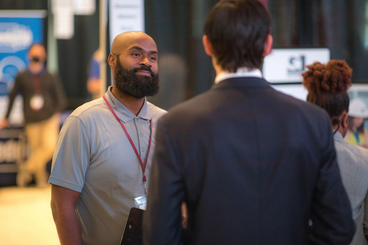 Career counselor talking to an interested student at the 2022 Engineering Career Fair.