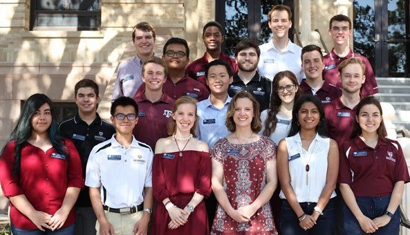 Eighteen young adults in the Engineering Honors Executive Board smiling and standing outdoors