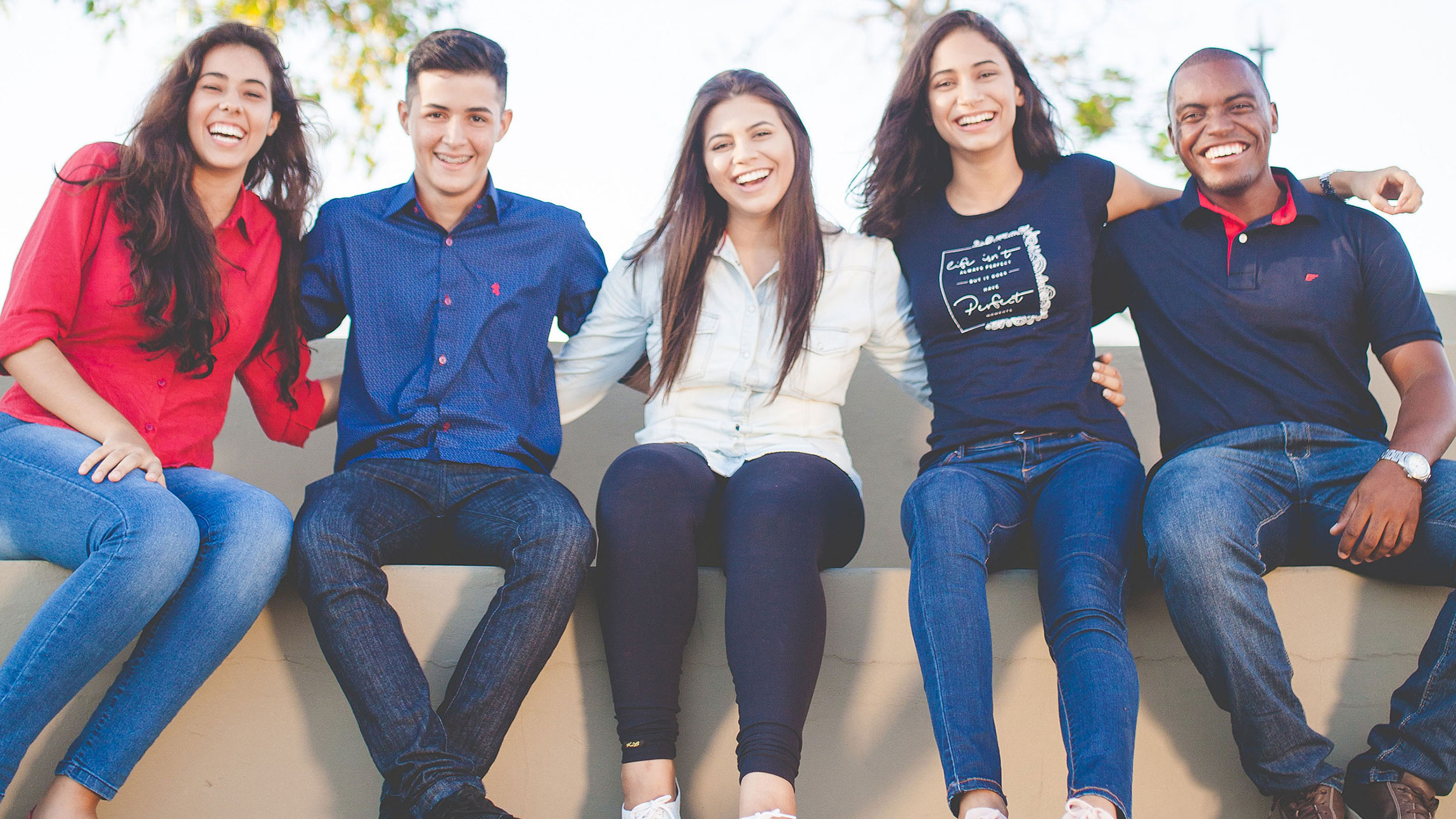 group of students sitting together smiling