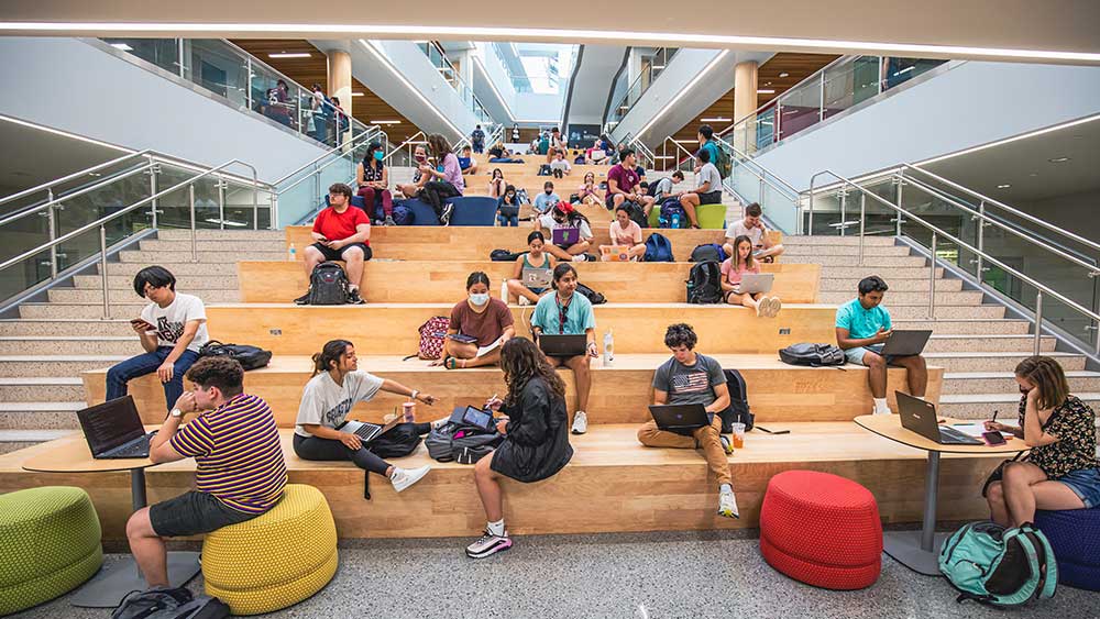 Students studying on massive stairs