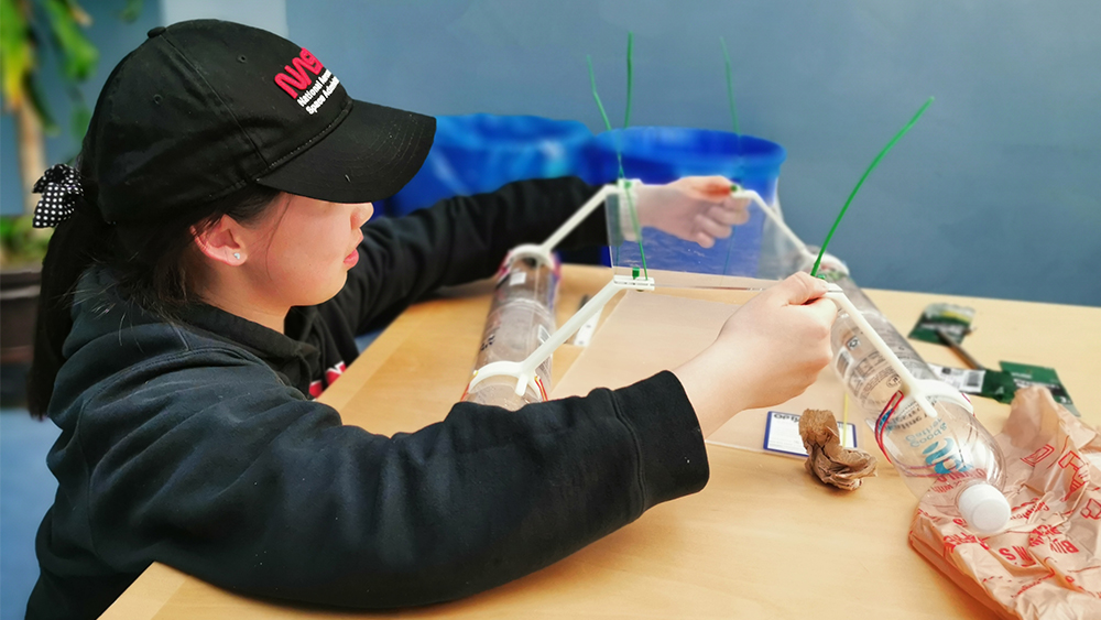 A female student works on a prototype for a remote-controlled water vehicle