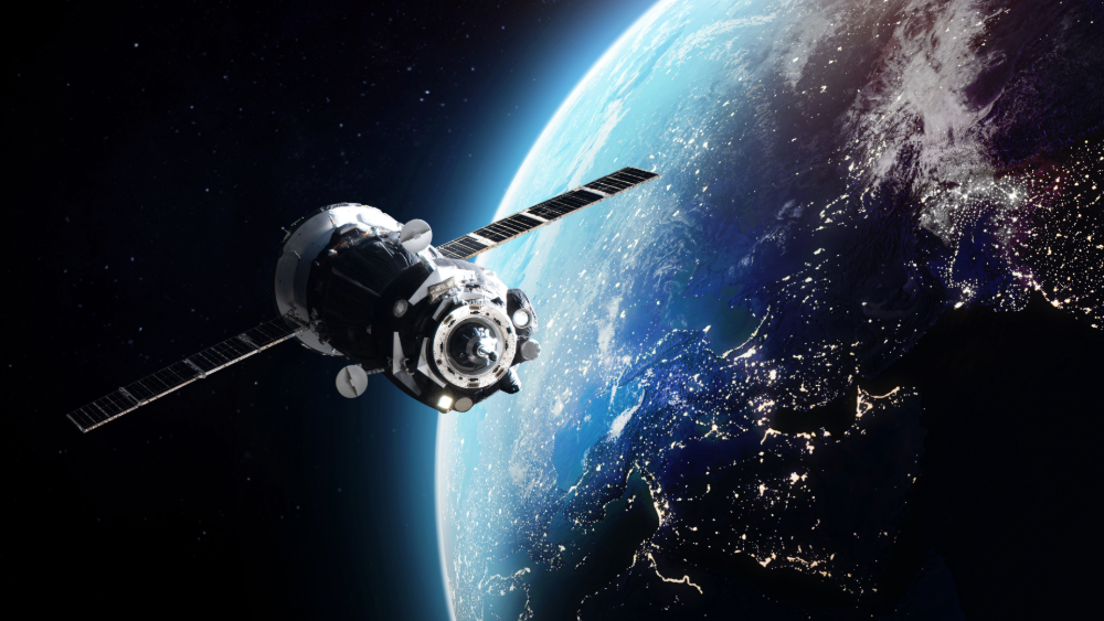 Satellite in front of Earth in space.