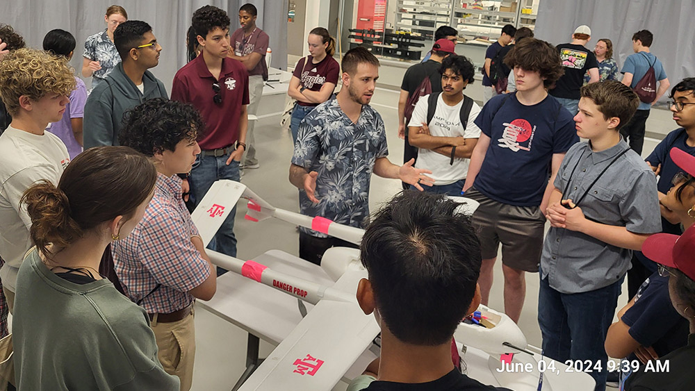 A group of high school students touring the Vehicle Systems Control Laboratory