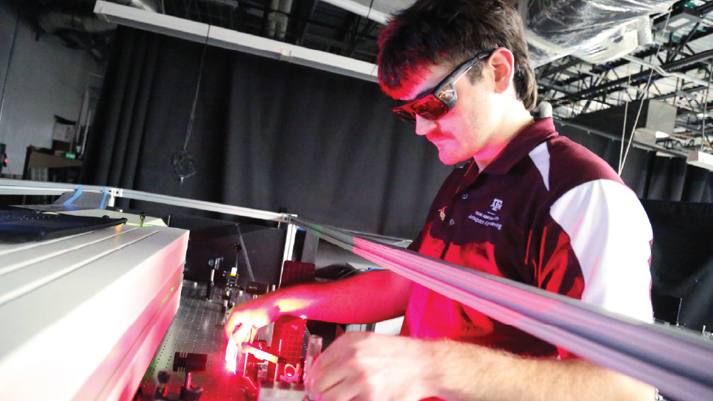 student wearing safety glasses and working with lasers in an aerospace engineering lab