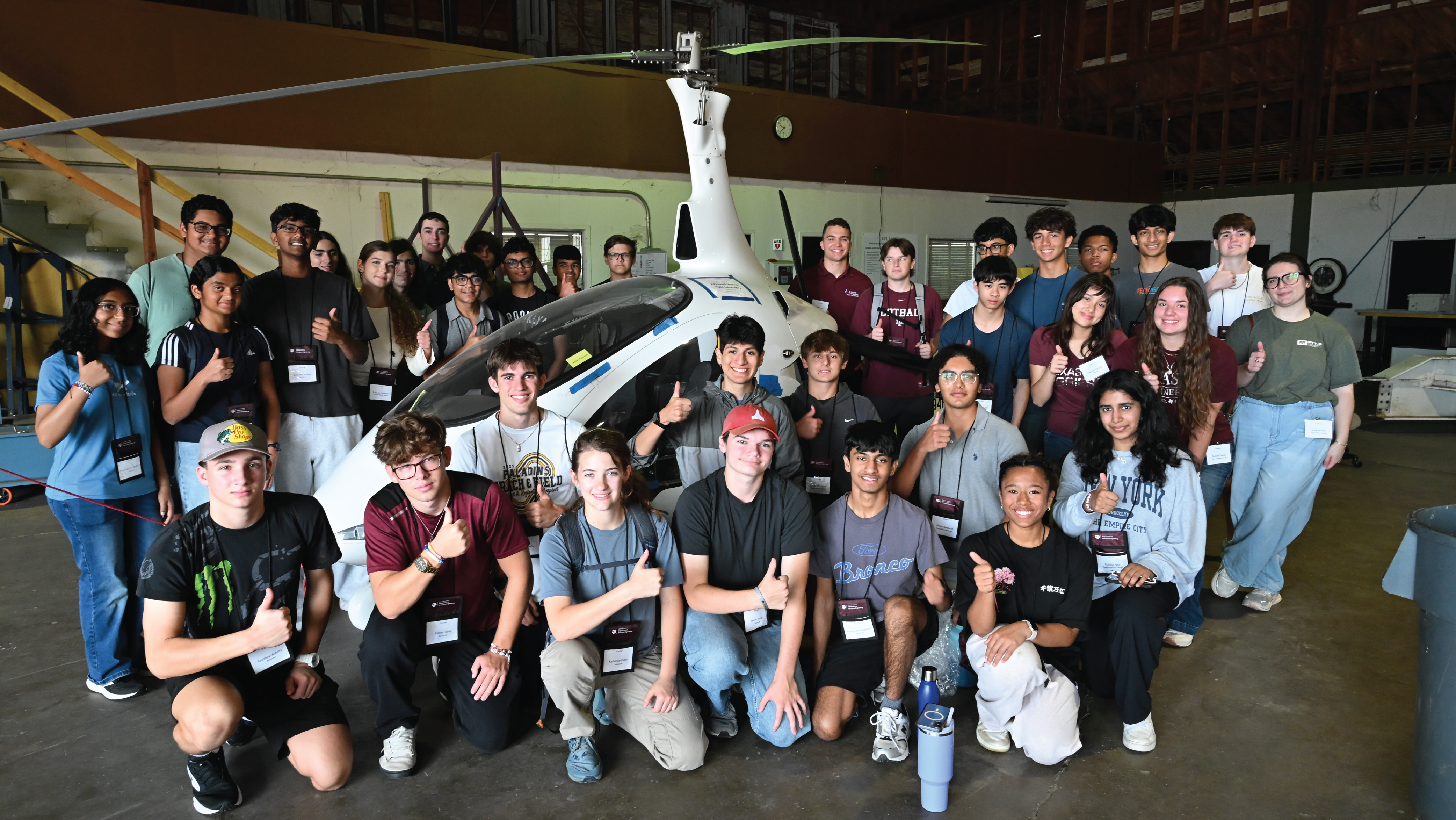 Group of students in front of helicopter at camp soar