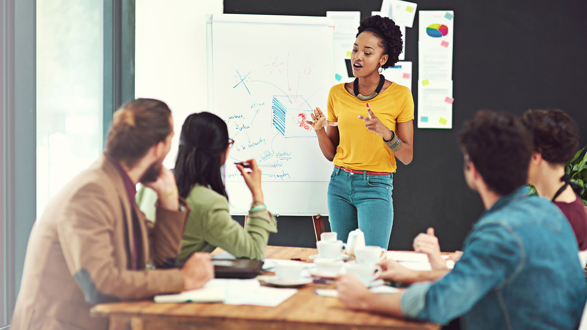 Woman presenting to a group in an office setting