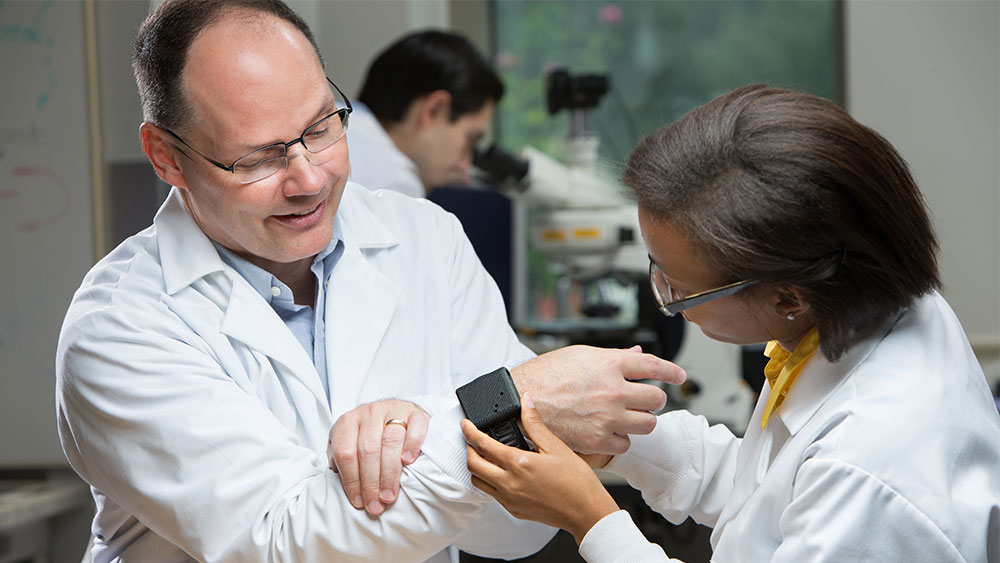 Dr. Cote in lab with student