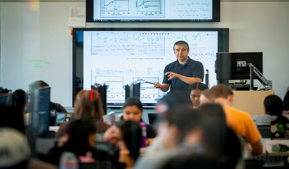 Dr. Gregory Reeves teaching and address a class room full of students 