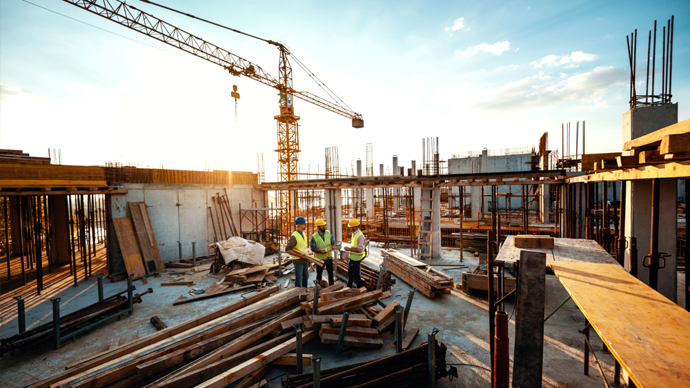 Construction site with materials and three men 