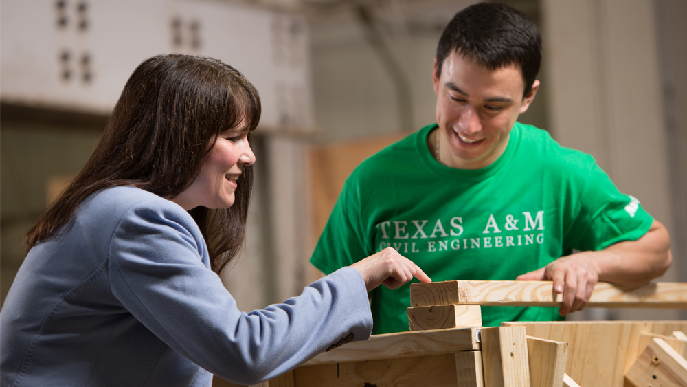 A professor and student work in a construction lab 