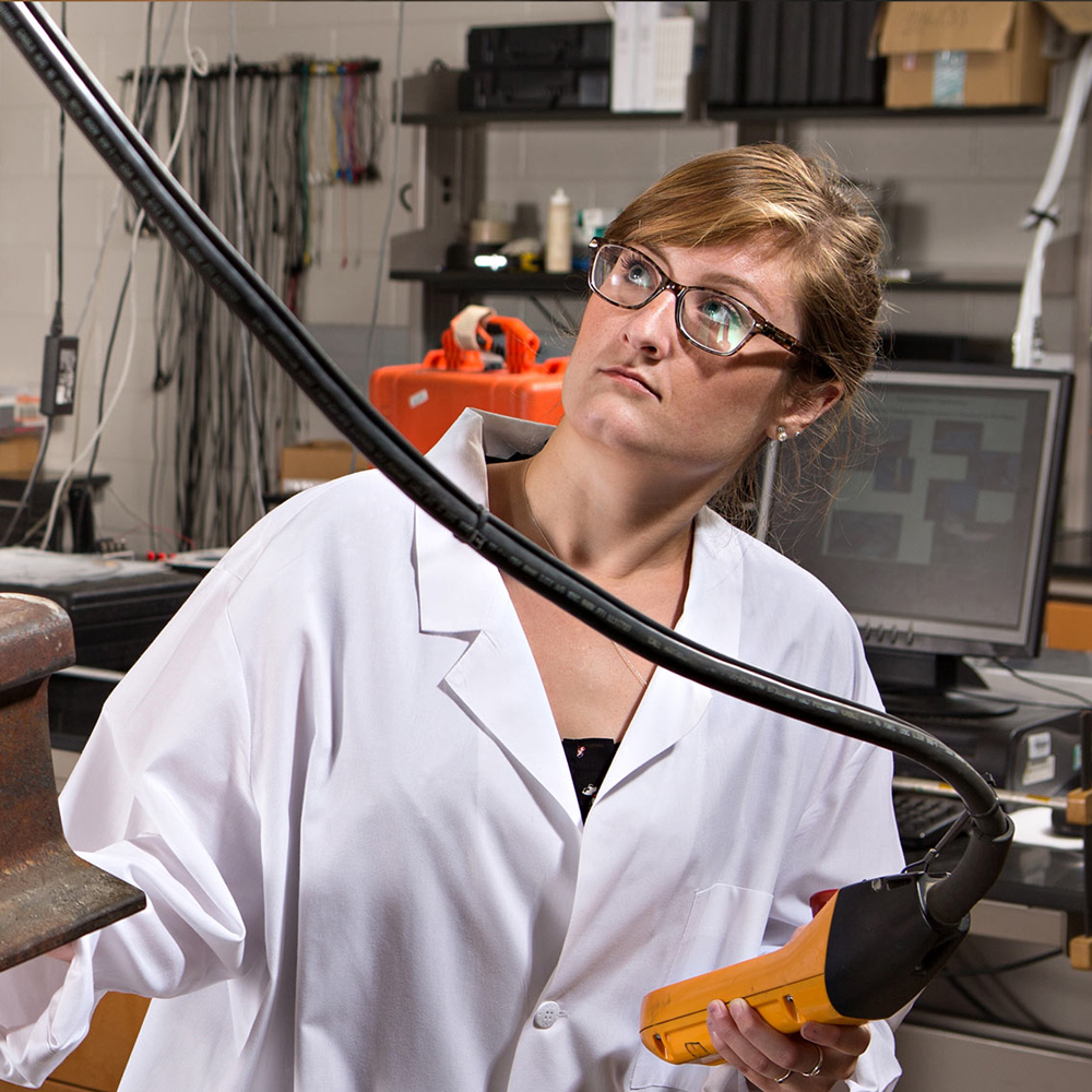 Student inspects a structural beam