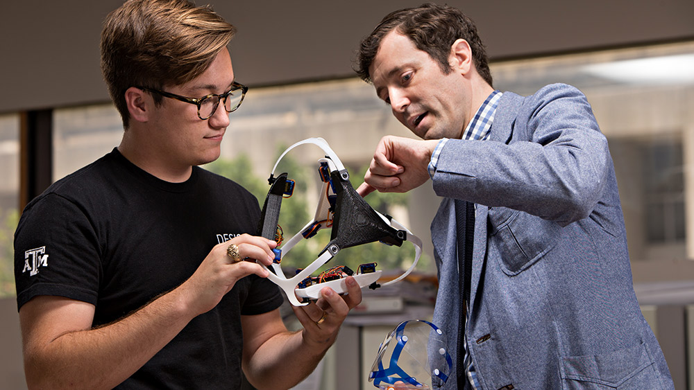 Professor and student looking at headset