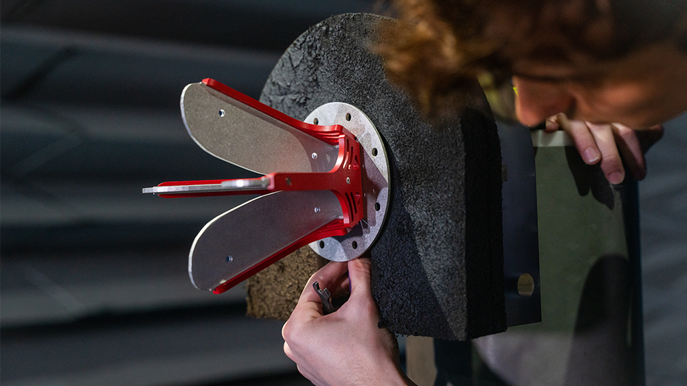 A person tuning a piece of lab equipment used in electromagnetics.