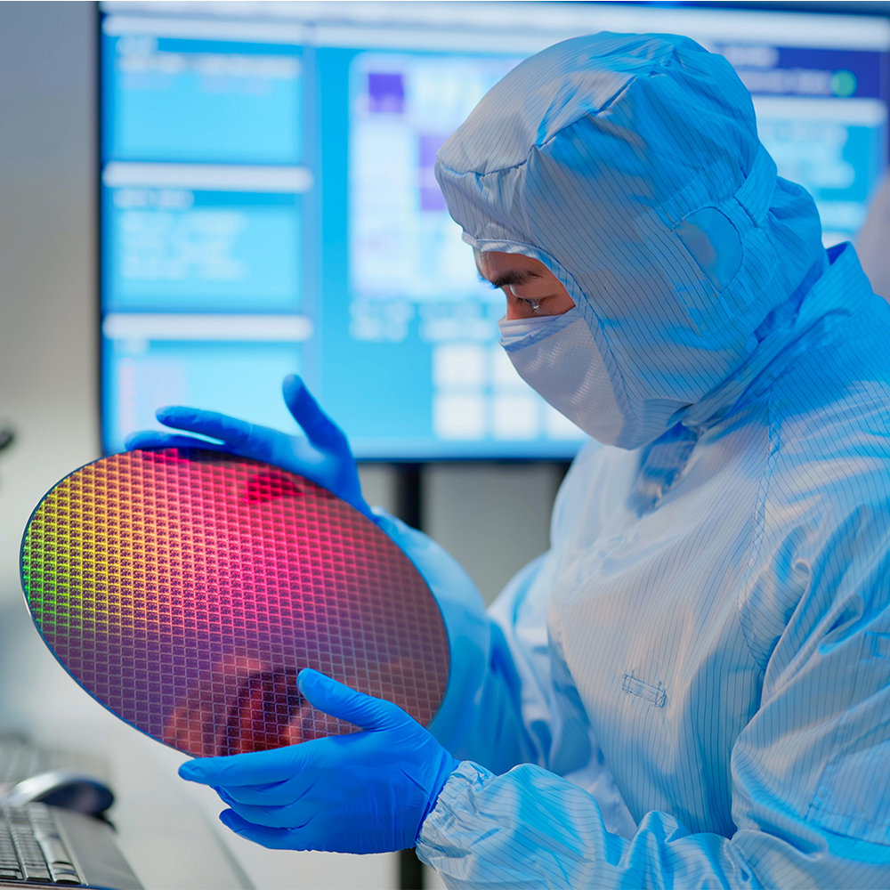 Person in a lab holding a disk.