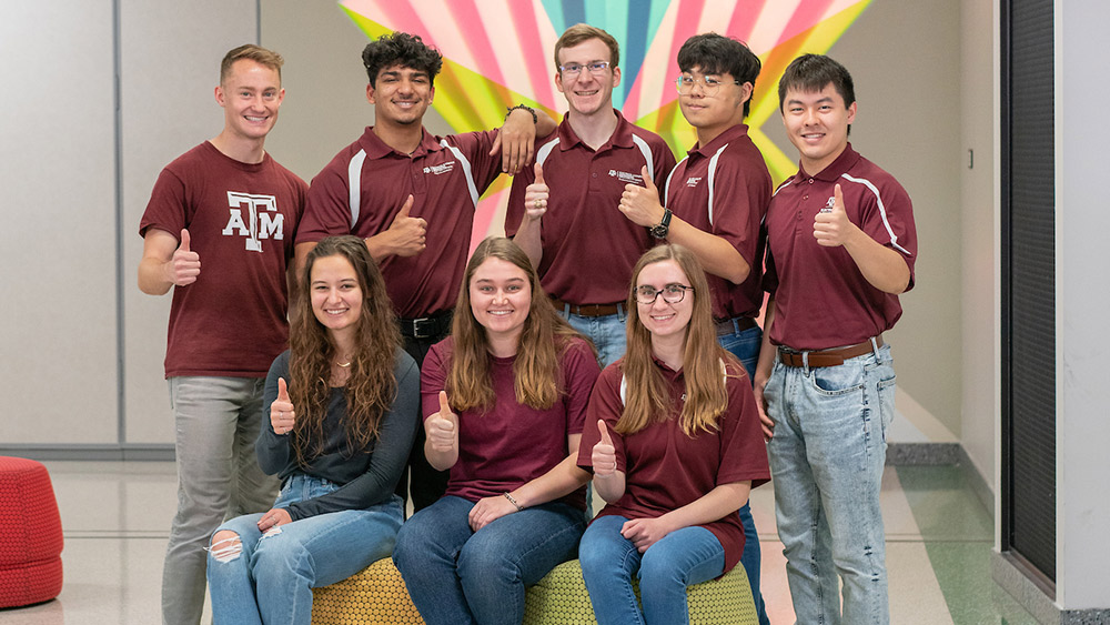 A group of college students standing in two rows