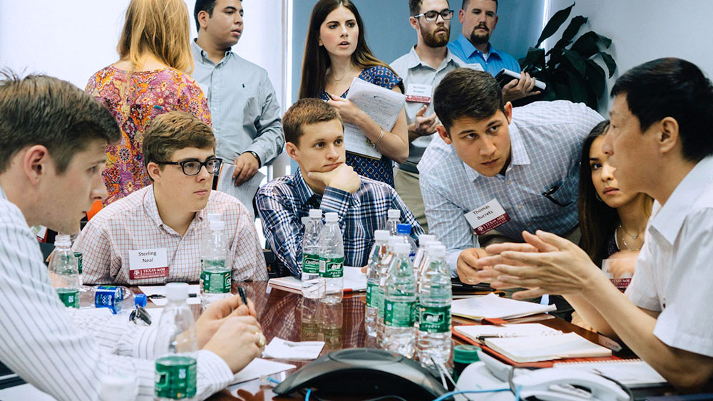 students at table with industry mentor on China trip