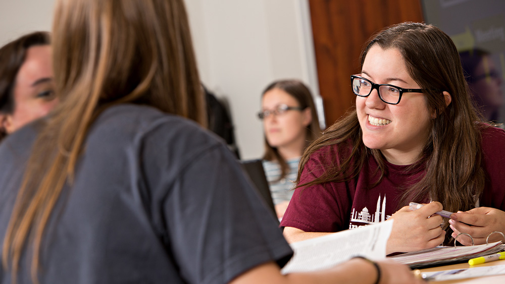 Industrial engineering students sitting at a table.