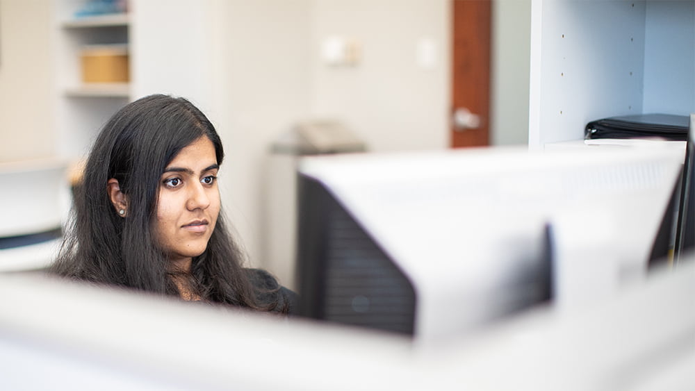 Student sitting at computer. 