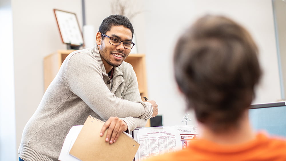 Two students talking to each other. 