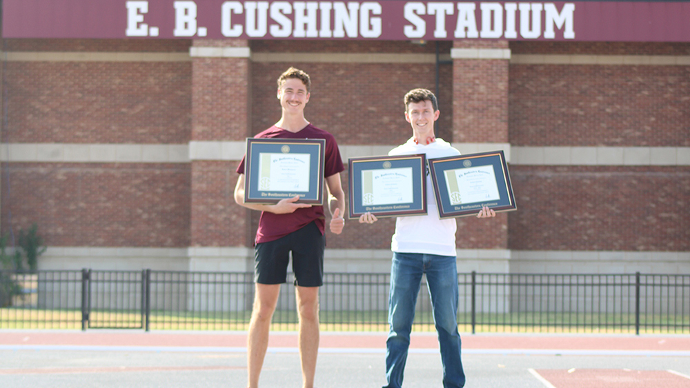 Samuel Whitmarsh (left) and Colton Colonna (right) holding their academic honor roll plaques at E.B. Crushing Stadium at Texas A&M.