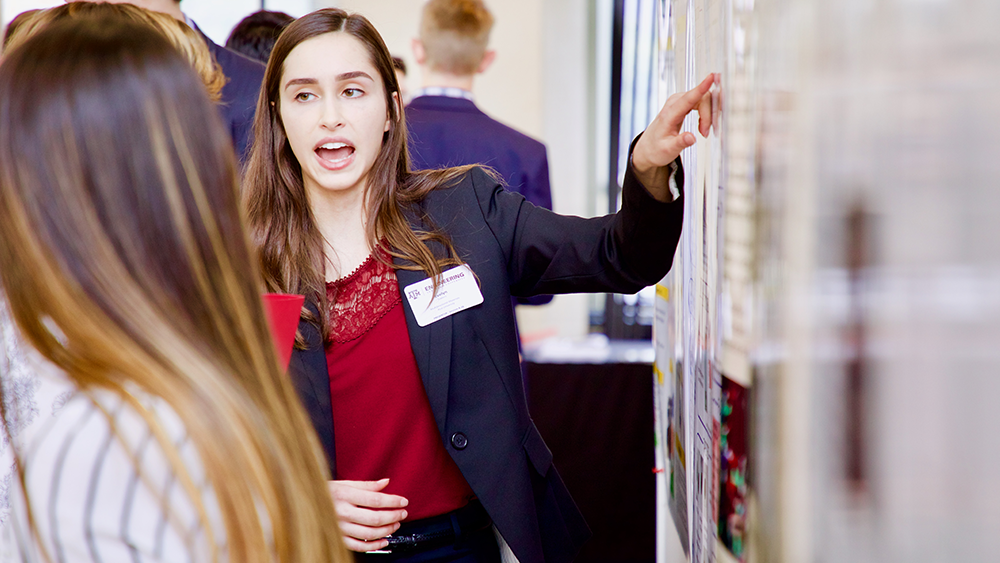 Student presents a poster