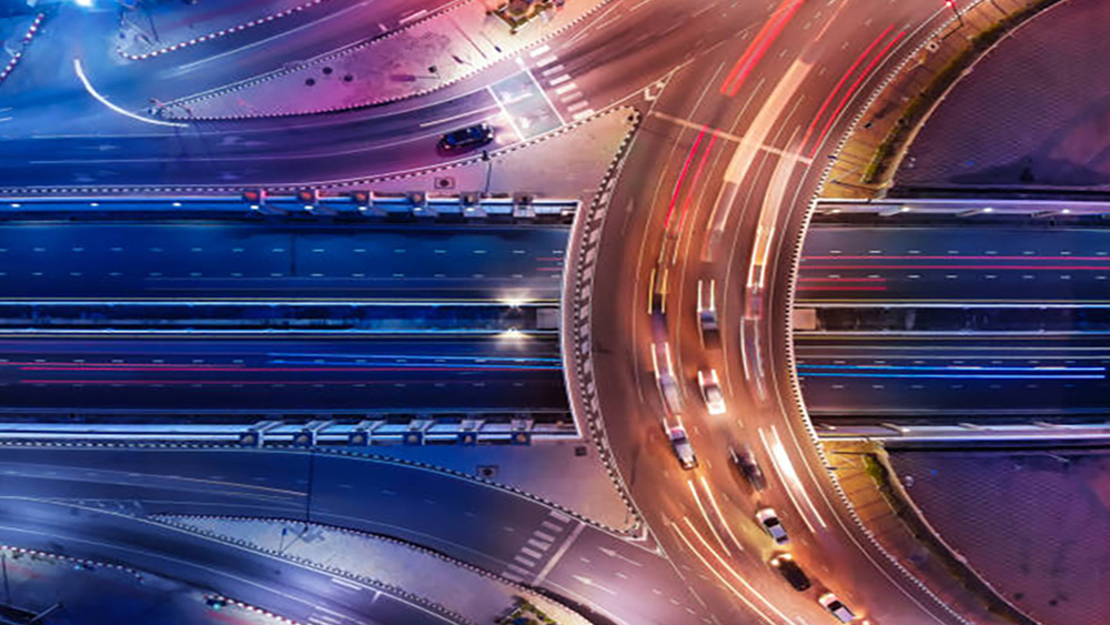 An aerial view of a city intersection at night.