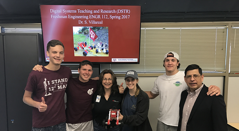 ENGR 112 freshman engineering students and Texas Instruments employee with digital systems teaching and research (DSTR) Robot.