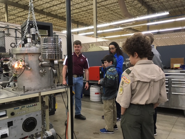 Texas A&amp;M showing piece of equipment to boy scouts.