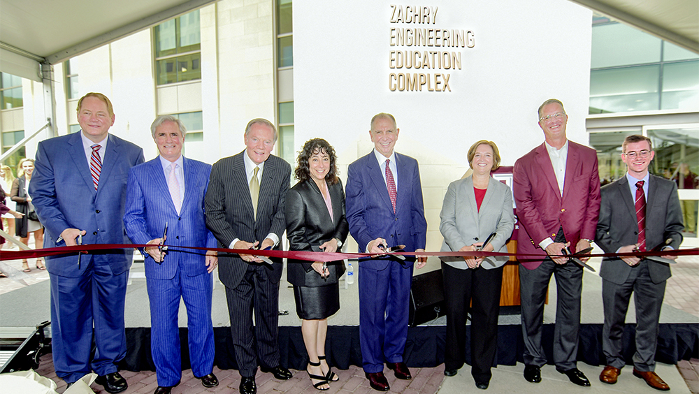 People cutting ribbon at ceremony.