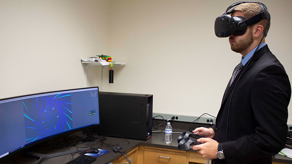 Students Justin McGinnity and Cody Piercey work alongside Texas A&amp;M Engineering IT to design VR programs for companies. 