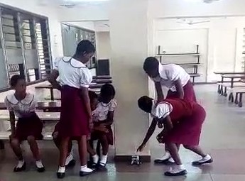 Girls in Ghana test their Lego robot.