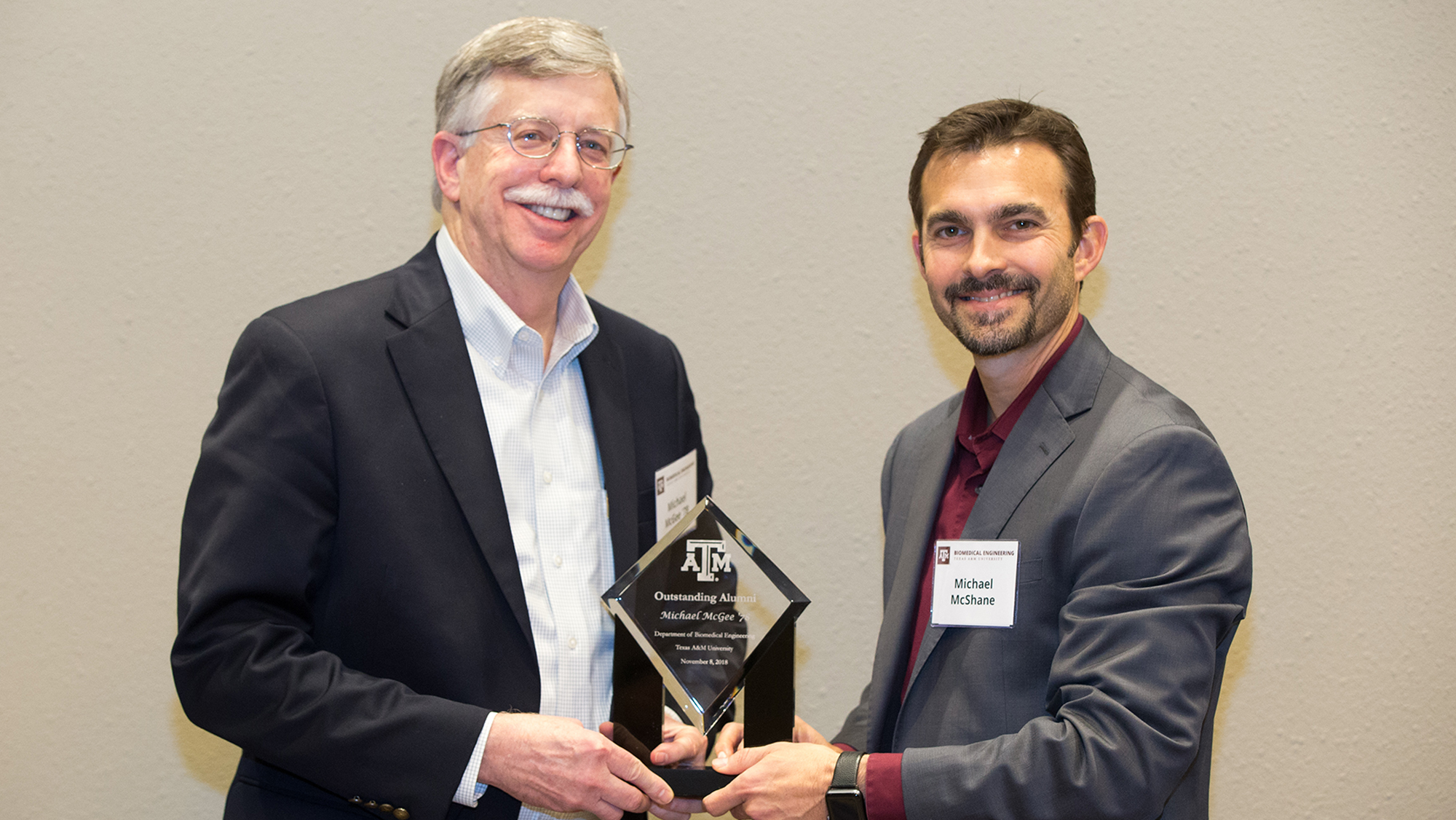 Mike McGee is presented with the BMEN Outstanding Alumni Award by Dr. Michael McShane