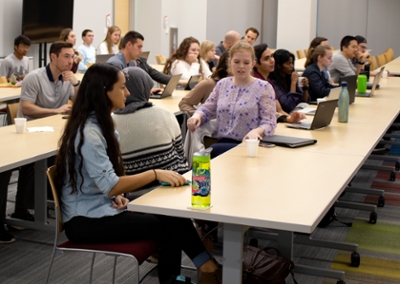 Students sit in the Zachry Building before the Experts Panel starts.