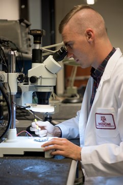 researcher with microscope