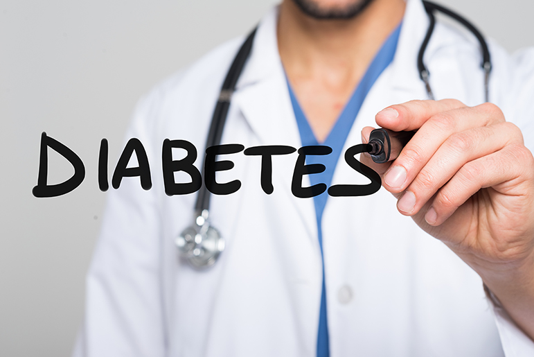 Doctor writing Diabetes on a glass