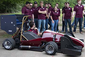 team inspecting car