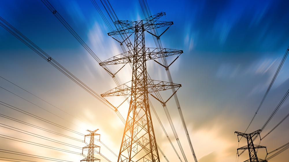 Power lines against a sunset background