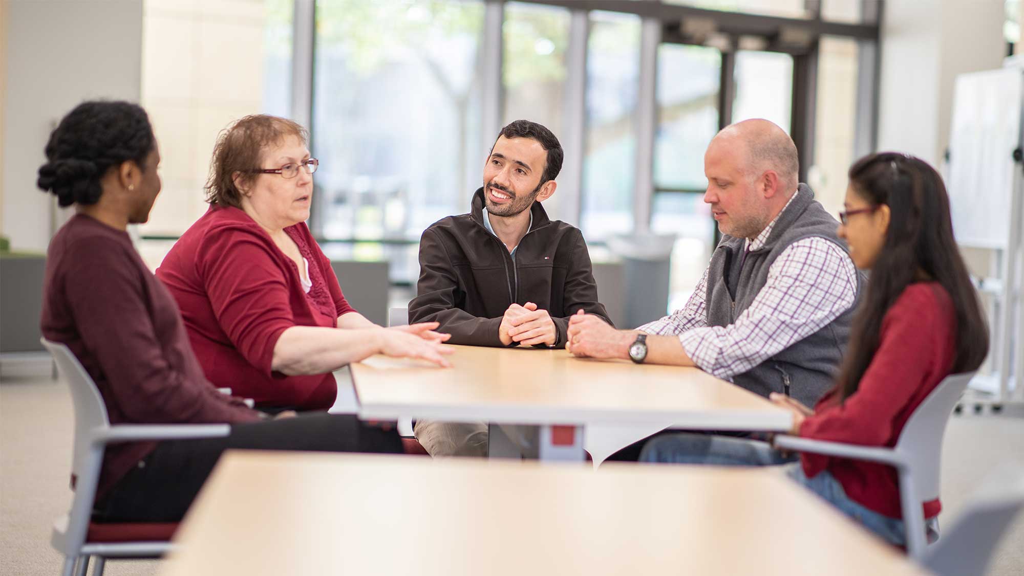 Group of graduate students and advisors talking