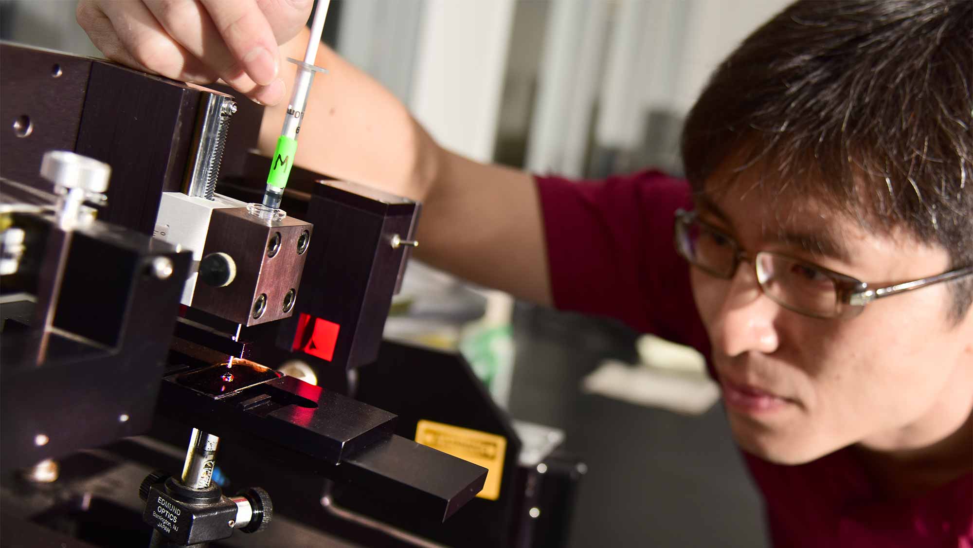 Student working with machinery in a lab