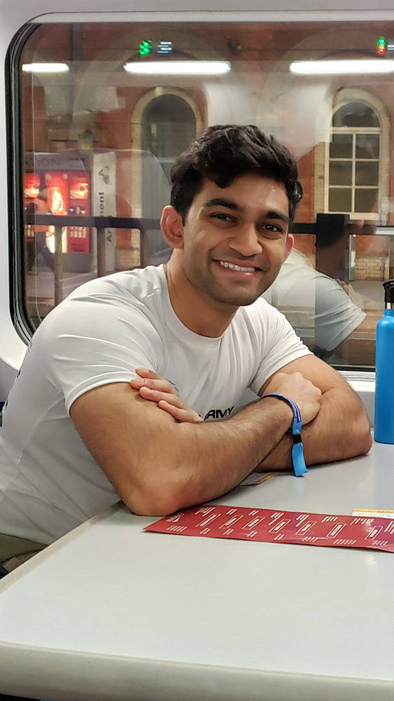 A former student, Ravi Lad, poses for a photo on a train.