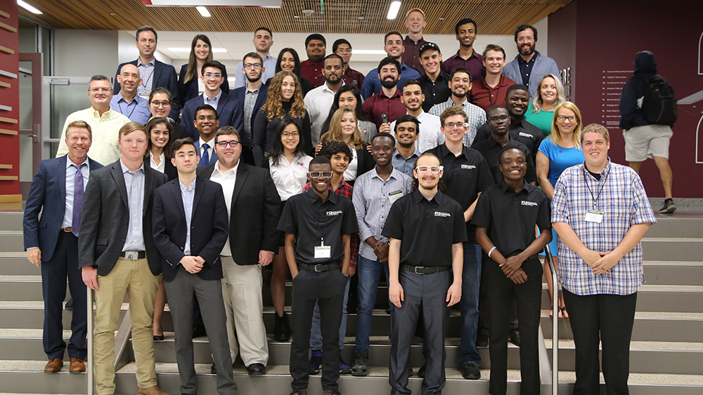 All team members and mentors pose for a group photo