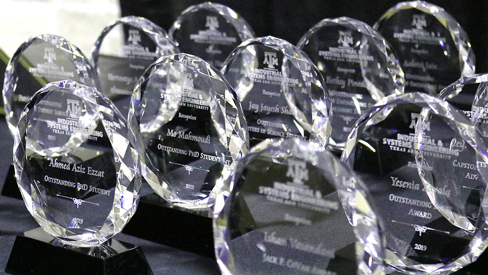 Awards lined up on a table. 