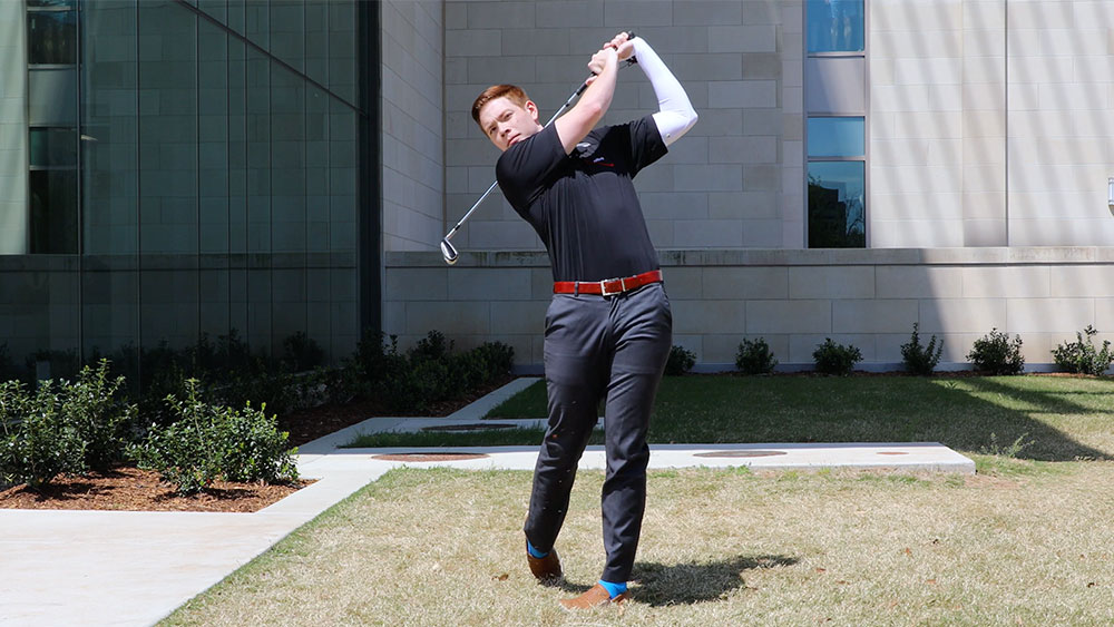 Student demonstrates the swing sleeve in action, measuring a golf swing and analyzing improvements.