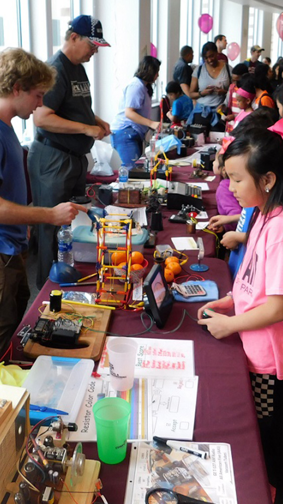 Future students learn from various activities on display to learn more about electrical engineering concepts from current students.